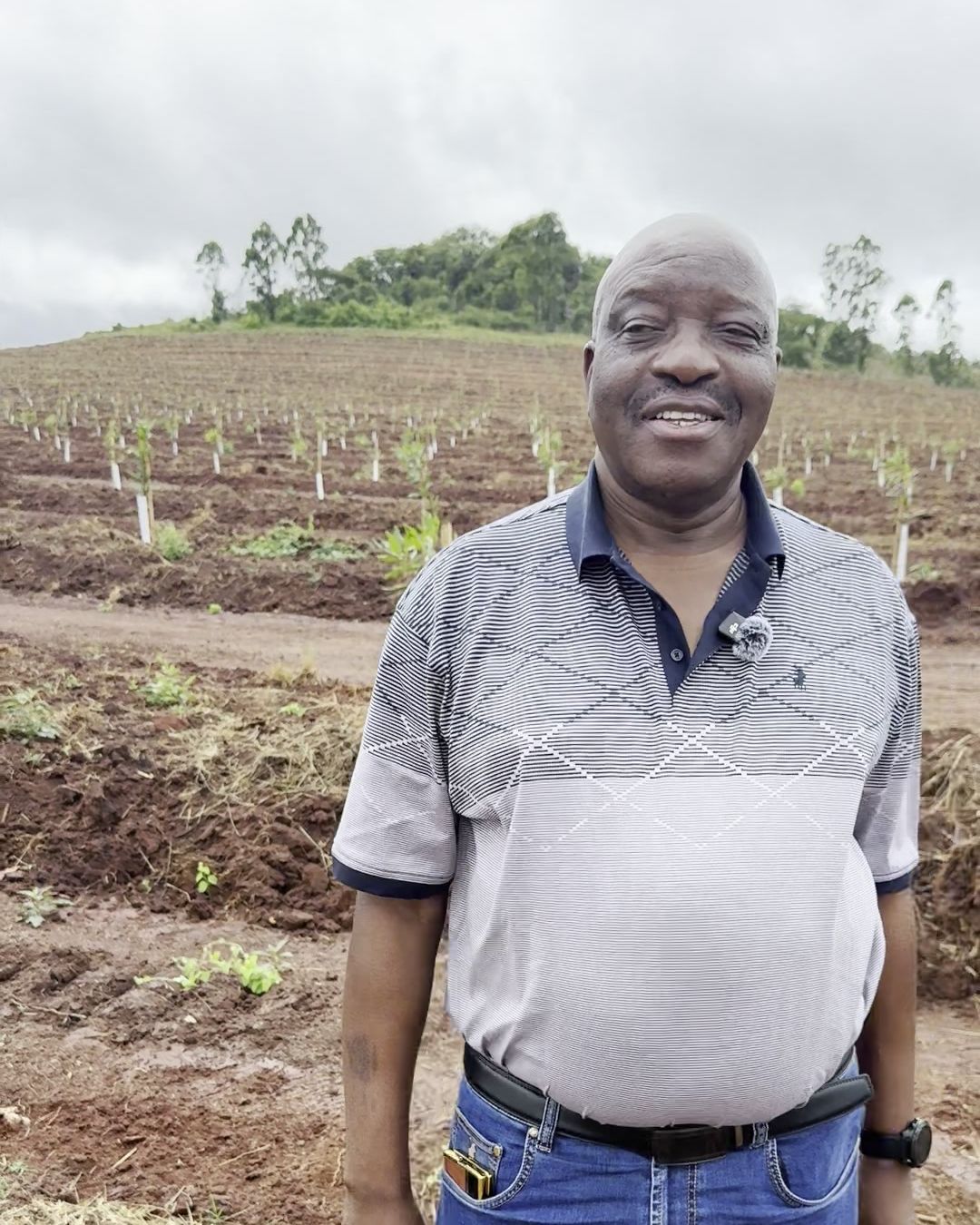 Doctor Maphaphane smiling in front of his newly replanted macadamia orchard